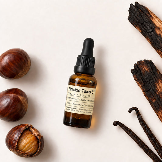 Charabanc Aroma NO.51 Fireside Tales 30ml diffuser oil with roasted chestnuts, charred wood and vanilla pods on a warm-white background.