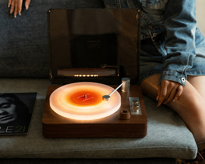 Atmosphere Engine glowing warm on a walnut console