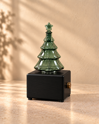 Black Christmas tree diffuser with unlit translucent green glass and a blank front panel.