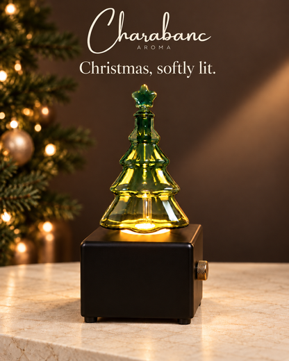 Black Christmas tree diffuser on a cream stone console in a warm brown Christmas setting.