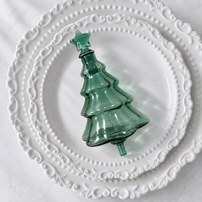 Green Christmas Tree Aroma Glass Bulb with star cap on a white porcelain plate