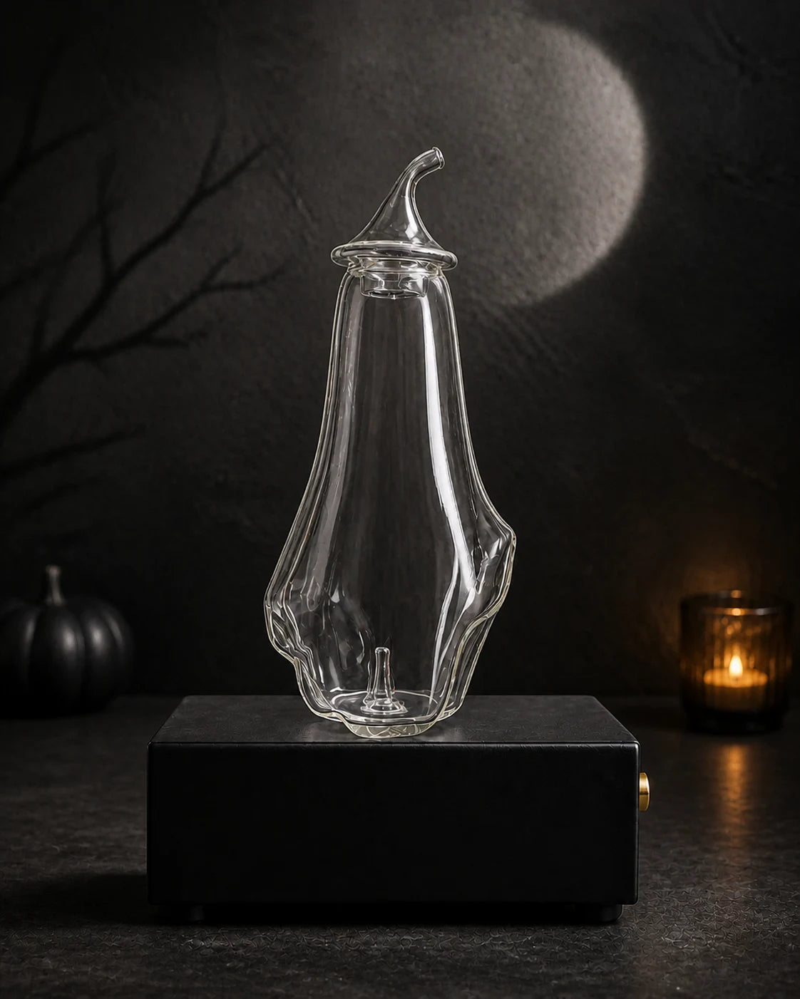 Blank hand-blown ghost bottle on the black rechargeable Charabanc MINI diffuser base in a moonlit Halloween setting