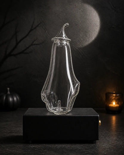 Blank hand-blown ghost bottle on the black rechargeable Charabanc MINI diffuser base in a moonlit Halloween setting